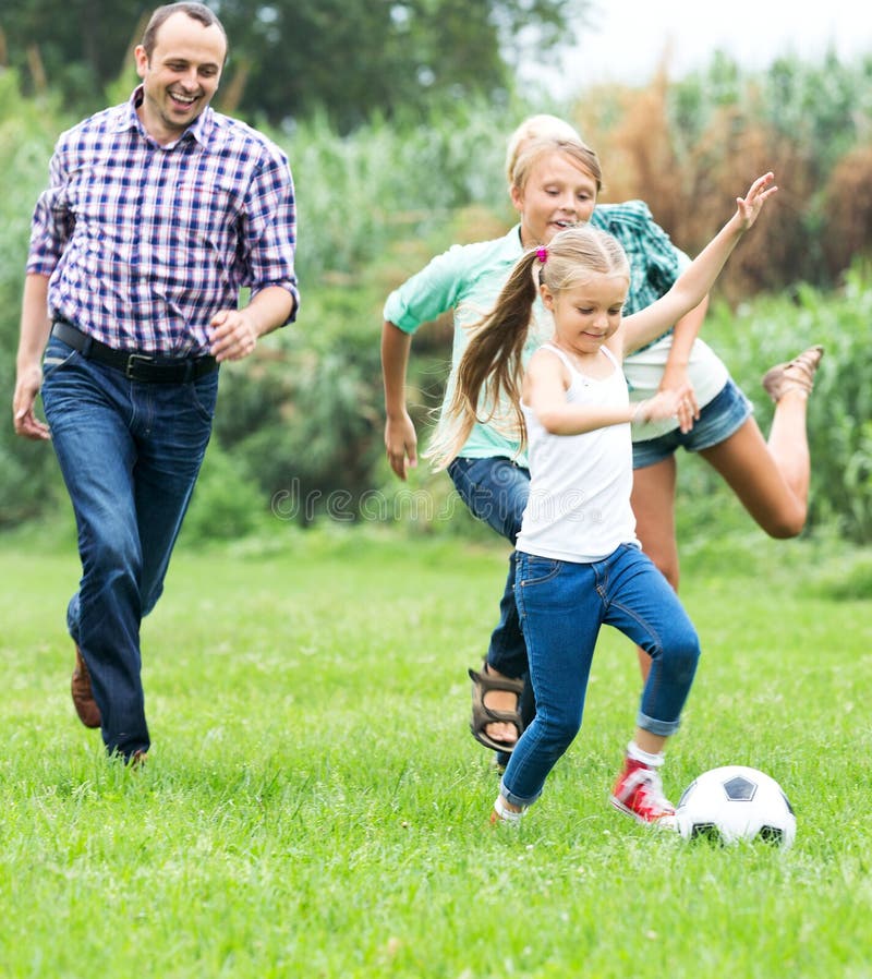 Happy family playing the ball