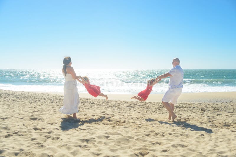 Happy family playing on the beach