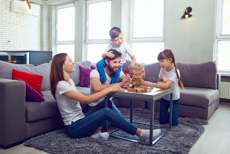 Happy family playing board games at home.