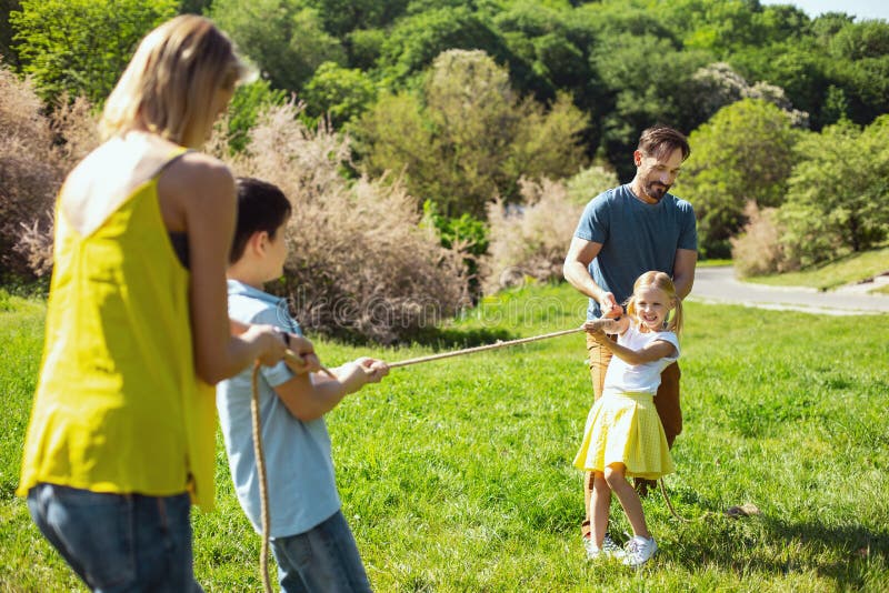 Happy family playing a game in the park stock image Happy family playing a game in the park stock image