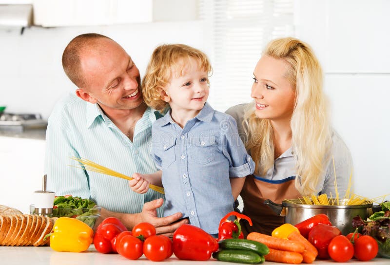 Happy family preparing a healthy dinner at home.