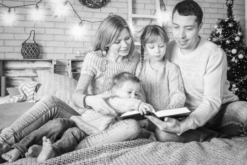 Happy Family Reading A Book At Home At Christmas Stock Photo Image Of happy-family-reading-a-book-at-home-at-christmas-stock-photo-image-of