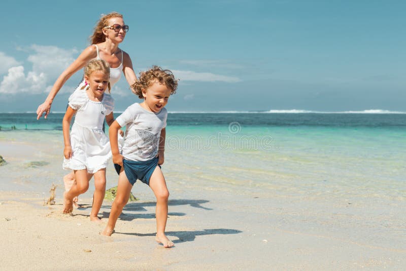 Happy family running on the beach