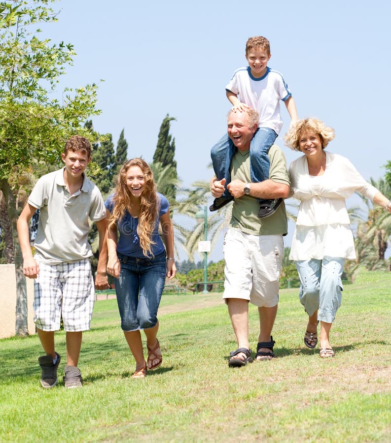 Happy family running towards camera stock photos