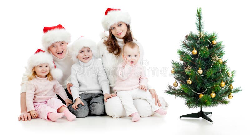 Happy family in Santa s hats with christmas tree