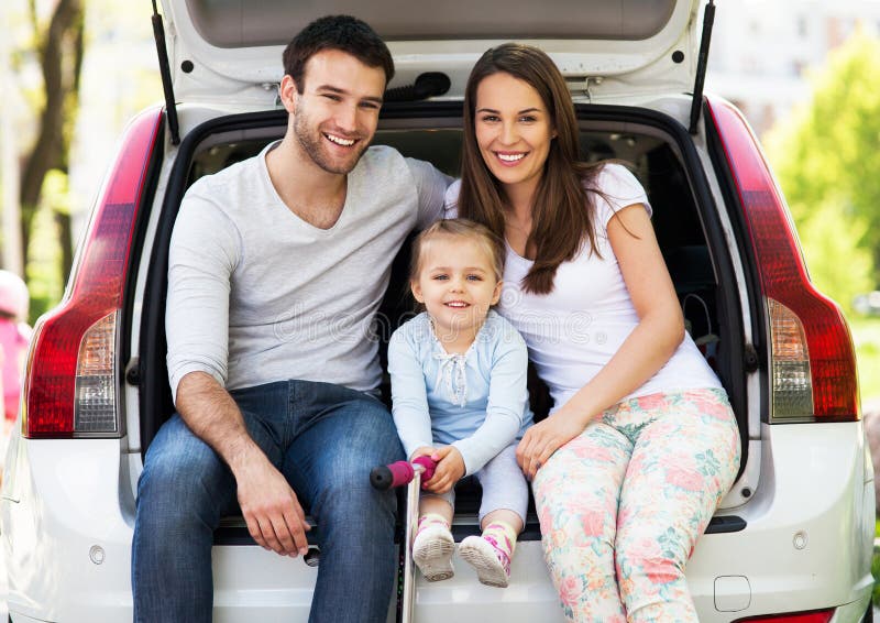 Happy family sitting in the car