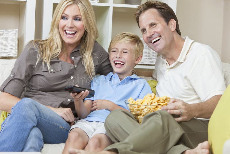 Happy Family Sitting on Sofa Watching Television stock photos Happy Family Sitting on Sofa Watching Television stock photos