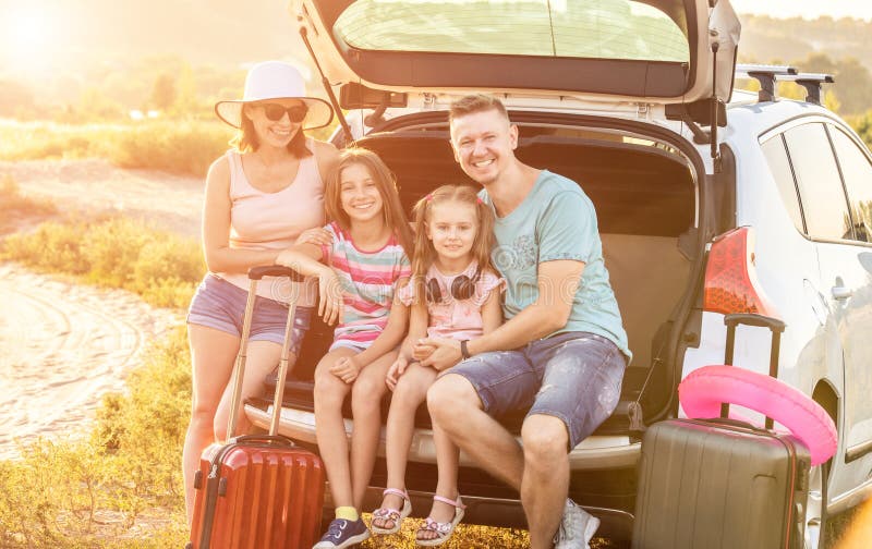 Happy Family Sitting on a Trunk of a Car with on a Travel Vacation ...