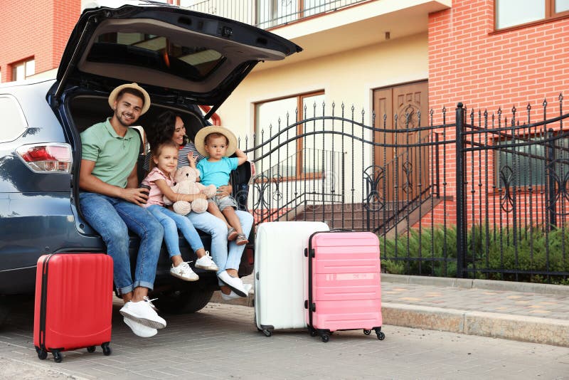 Happy family with suitcases near car in street royalty free stock photos Happy family with suitcases near car in street royalty free stock photos