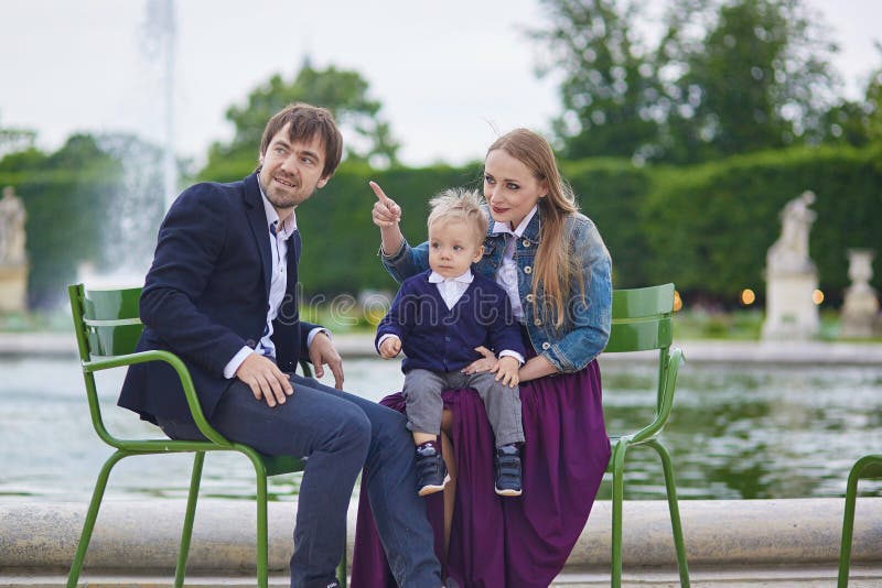 Happy family of three in Palais Royal in Paris