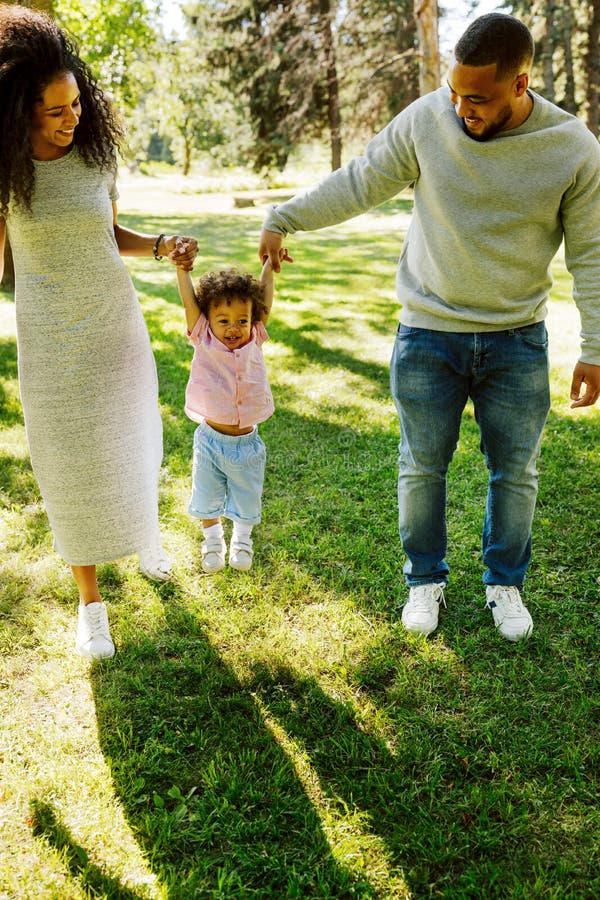 Happy family of three walking in park royalty free stock photos Happy family of three walking in park royalty free stock photos