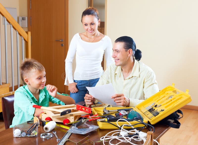 Happy Family Together Doing Something with Working Tools Stock Photo