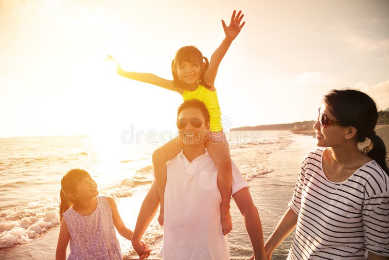 Happy family walking on the beach royalty free stock images Happy family walking on the beach royalty free stock images
