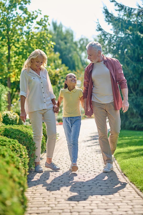 Happy Family Walking Hand in Hand in the Park Stock Photo Image of