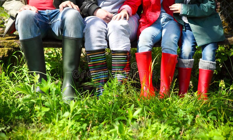 Happy family wearing colorful rain boots. Family concept