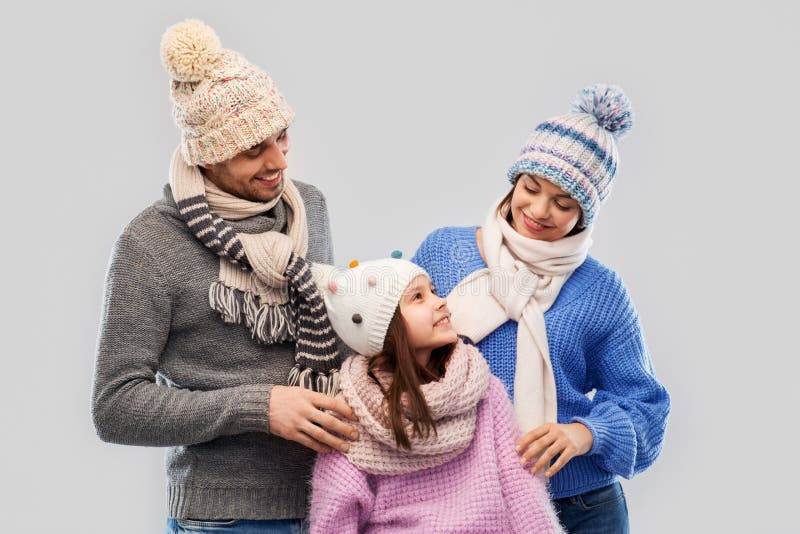 Happy family in winter clothes on grey background royalty free stock image Happy family in winter clothes on grey background royalty free stock image