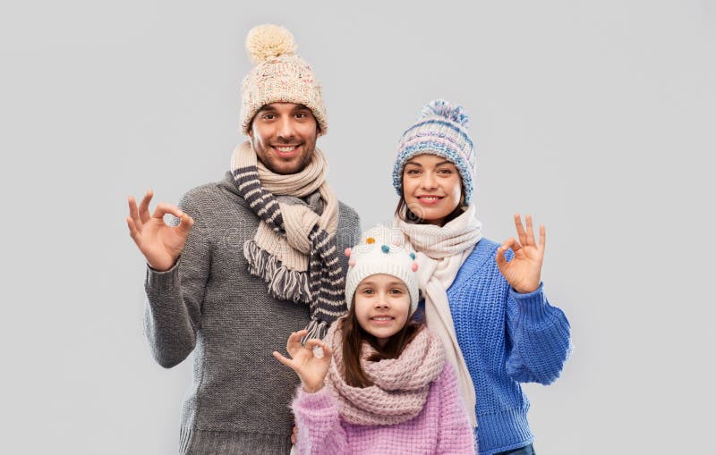 Happy family in winter clothes showing ok gesture stock photography Happy family in winter clothes showing ok gesture stock photography