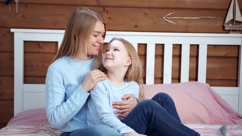 Happy Family Young Mother and Cute Little Daughter Smiling and Hugging Sitting on Bed at Home Stock Footage - Video of bedroom, cozy: 140050256