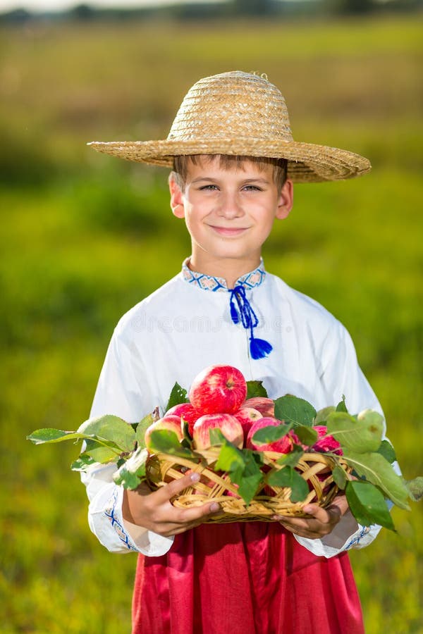 Happy farmer boy hold Organic Apples in Autumn Garden royalty free stock photography Happy farmer boy hold Organic Apples in Autumn Garden royalty free stock photography