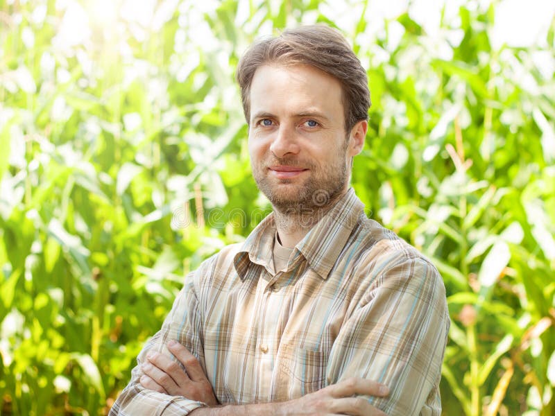 Happy farmer in front of his corn field