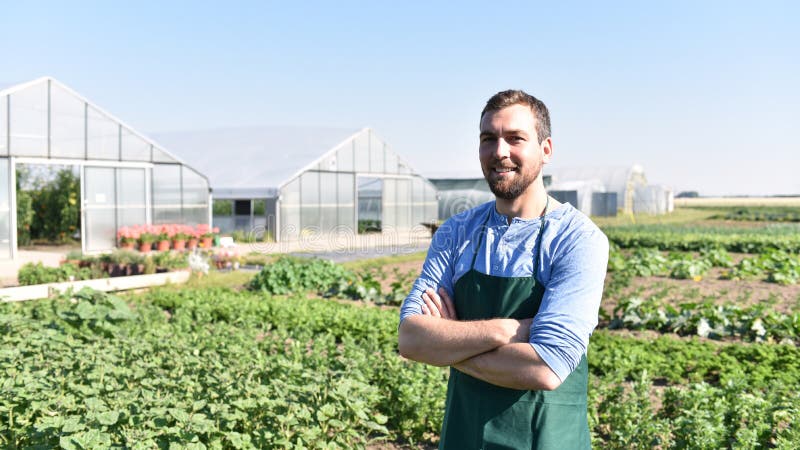 Happy farmer growing and harvesting vegetables on the farm stock photo Happy farmer growing and harvesting vegetables on the farm stock photo