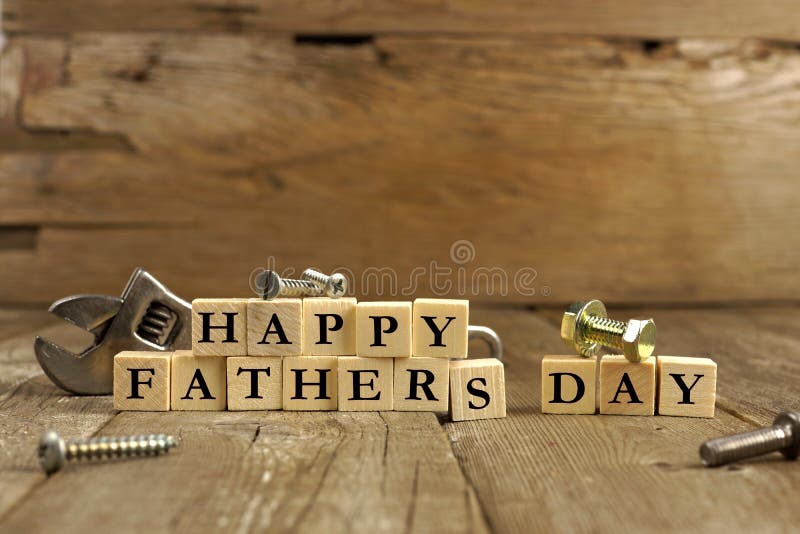 Happy Fathers Day blocks with tools on a rustic wood background. Happy Fathers Day blocks with tools on a rustic wood background