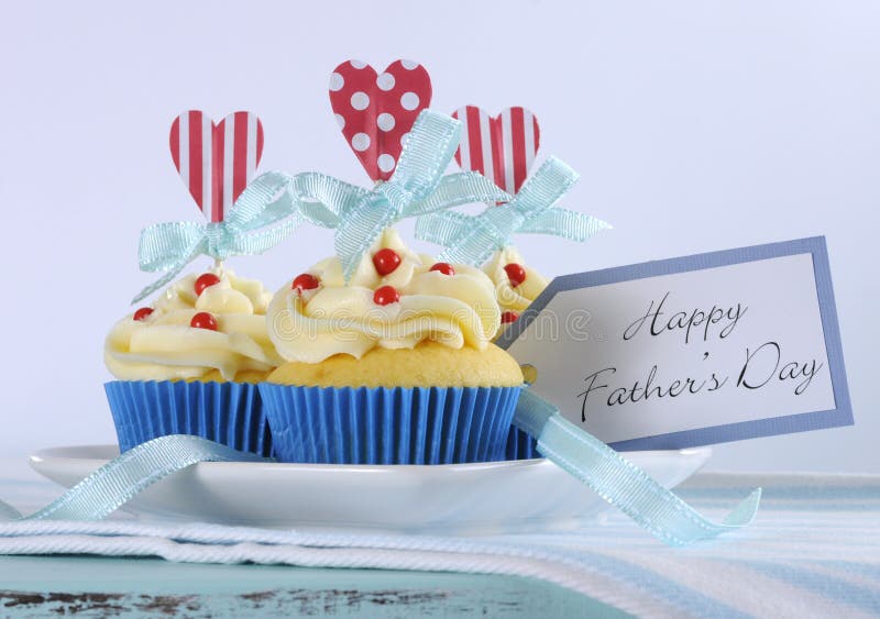 Happy Fathers Day bright and cheery red white and blue decorated cupcakes with heart toppers and gift tag