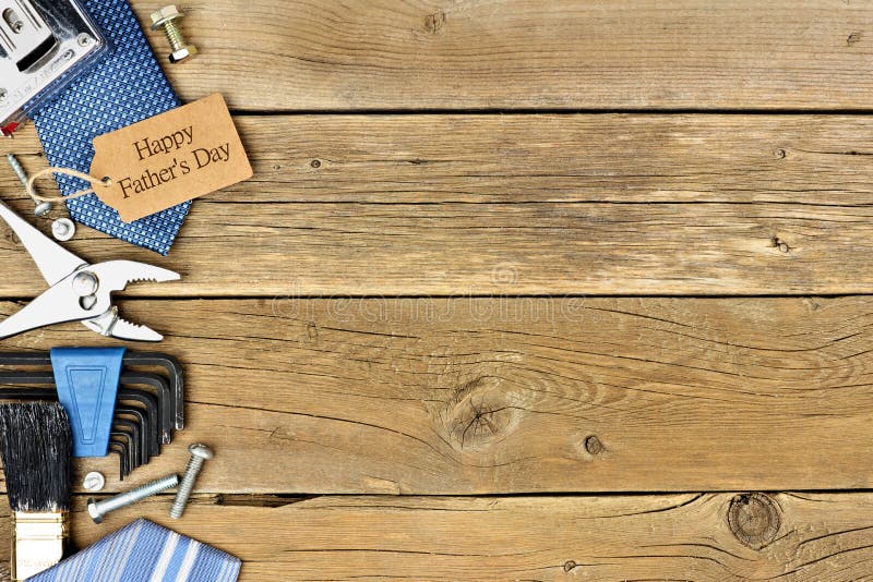 Happy Fathers Day gift tag with side border of tools and ties on a rustic wood background. Happy Fathers Day gift tag with side border of tools and ties on a rustic wood background