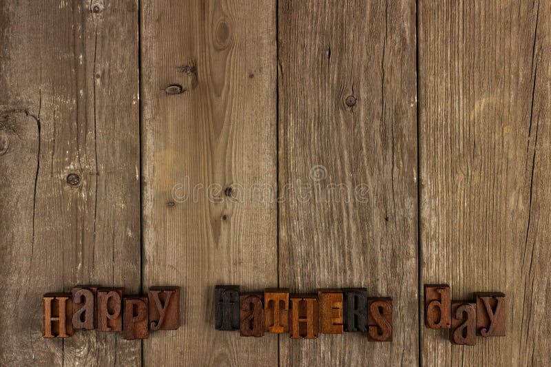 Happy Fathers Day vintage wood letters on a rustic wooden background. Happy Fathers Day vintage wood letters on a rustic wooden background