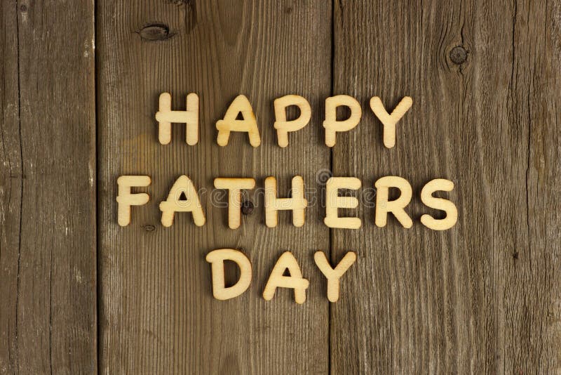 Happy Fathers Day wooden letters on a rustic wood background. Happy Fathers Day wooden letters on a rustic wood background