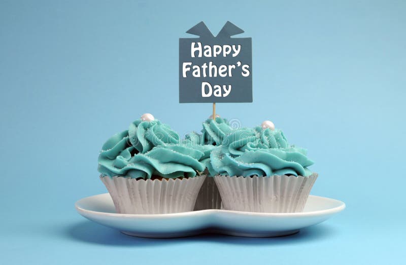 Happy Fathers Day special treat blue and white beautiful decorated cupcakes with message on blue background.