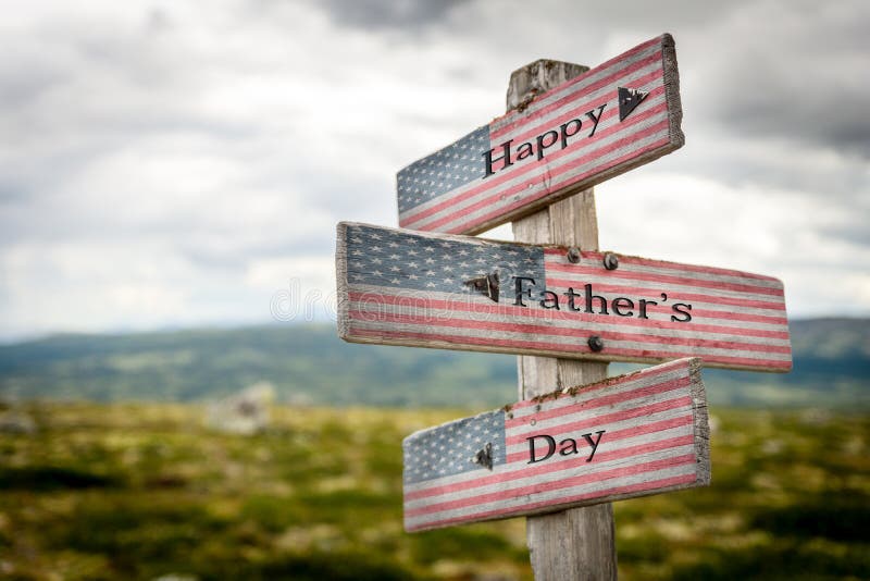 Happy fathers day text on wooden american flag signpost outdoors in nature