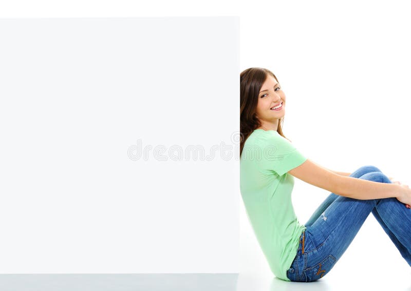 Happy female sitting on floor near white banner