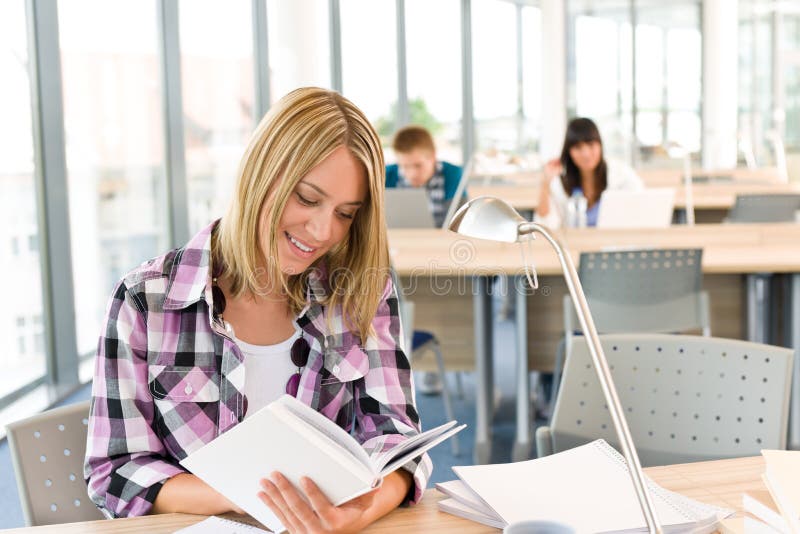 Happy female student with book stock image