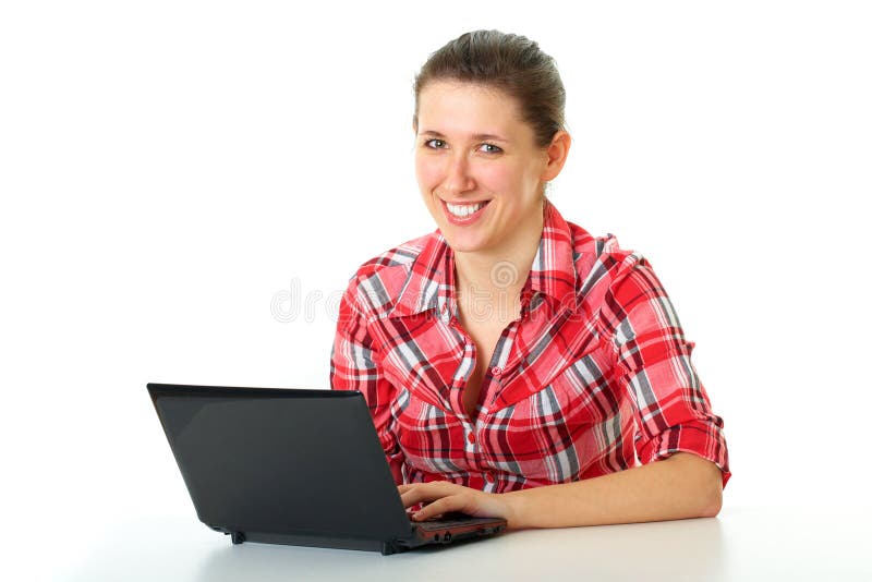 Happy female student in red shirt works on laptop