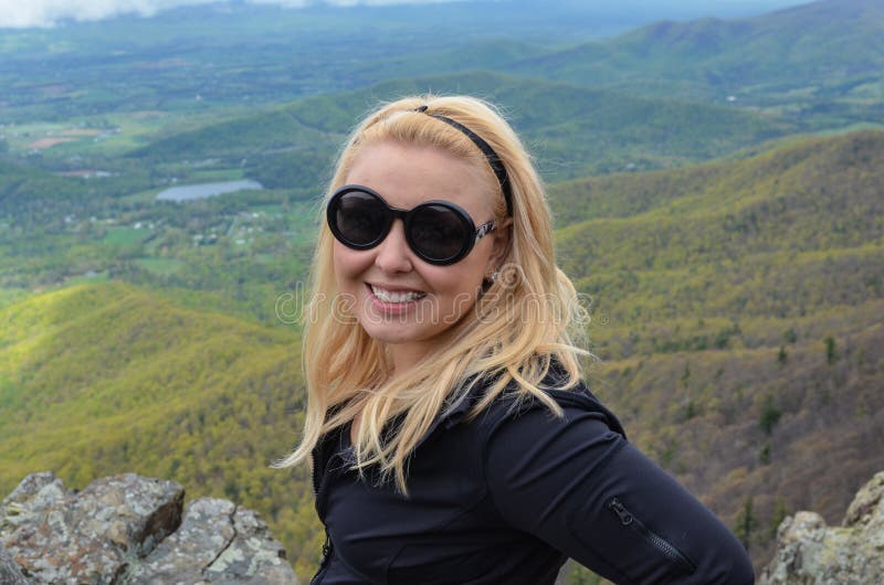 Happy female woman blonde hiker poses at the top of the Little Stony Man overlook in Shenandoah National Park in Virginia, looking stock photos Happy female woman blonde hiker poses at the top of the Little Stony Man overlook in Shenandoah National Park in Virginia, looking stock photos
