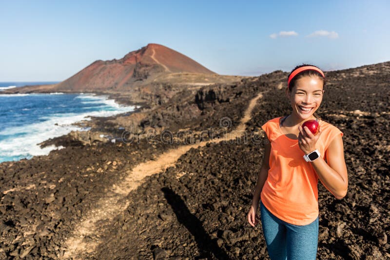 Happy fitness woman on hiking trail eating apple royalty free stock photo Happy fitness woman on hiking trail eating apple royalty free stock photo