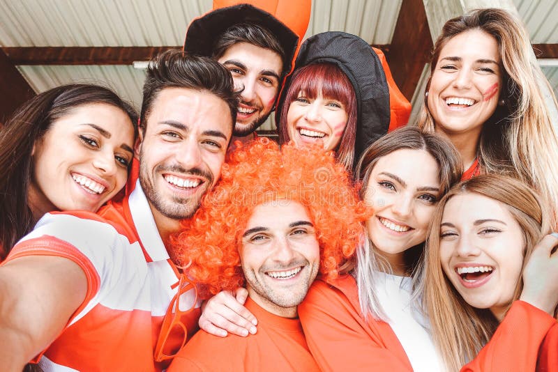 Happy football supporter fans taking a selfie before the world soccer game - Young group of excited friends having fun at stadium stock photo Happy football supporter fans taking a selfie before the world soccer game - Young group of excited friends having fun at stadium stock photo
