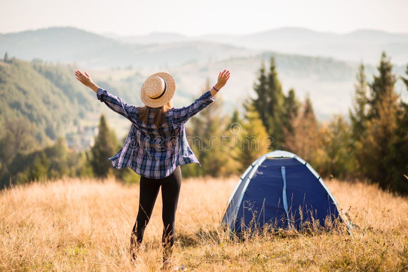 Happy freedom girl in straw hat with hands up in mountains travel royalty free stock photo Happy freedom girl in straw hat with hands up in mountains travel royalty free stock photo