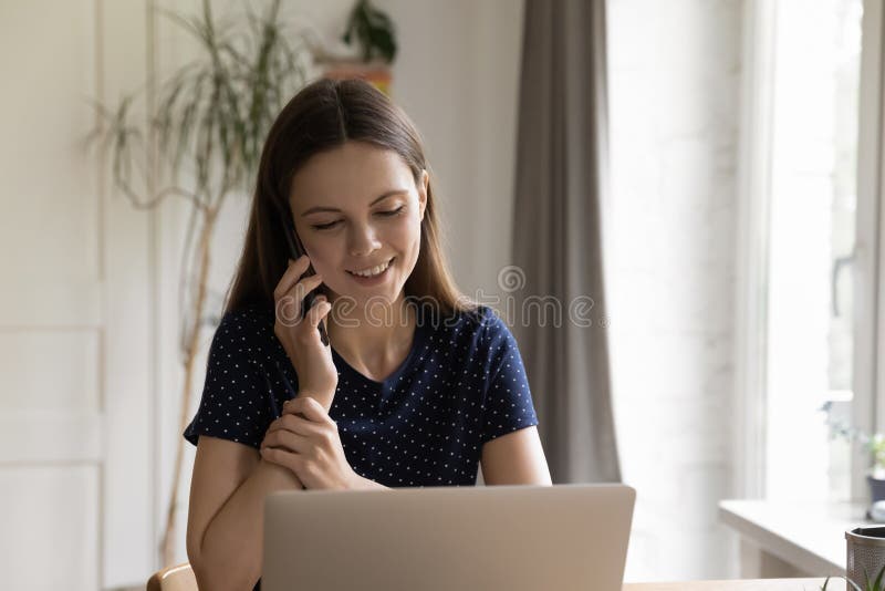 Happy Freelance Worker Woman Answering Telephone Call in Home Office