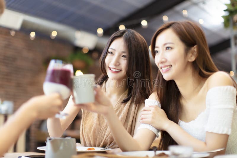 Friends Celebrate with Toast and Clink in Restaurant stock image Friends Celebrate with Toast and Clink in Restaurant stock image