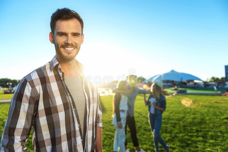 Happy friends chatting together while guy looking into camera stock photography Happy friends chatting together while guy looking into camera stock photography