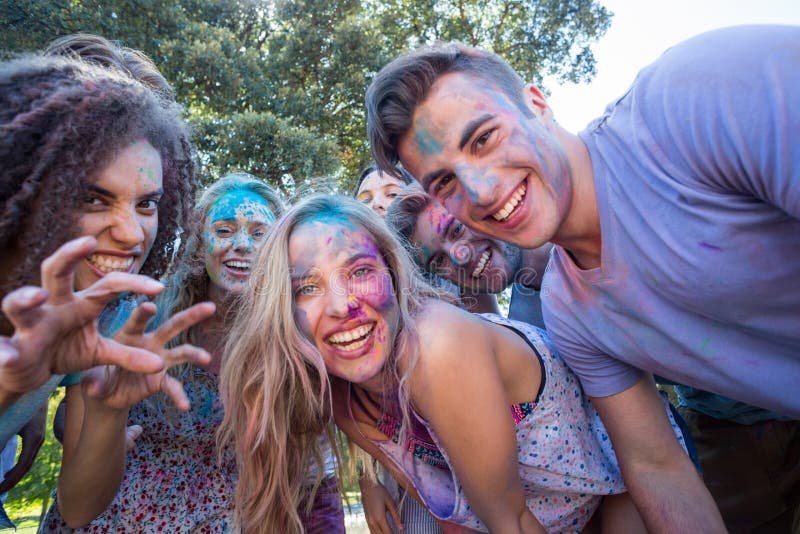 Happy friends covered in powder paint royalty free stock images