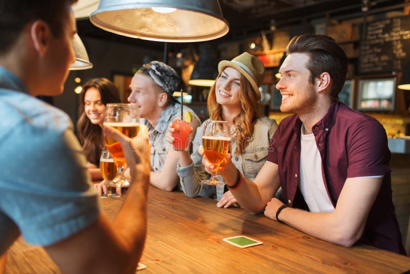 Happy Friends With Drinks Talking At Bar Or Pub Stock Photo Image Of