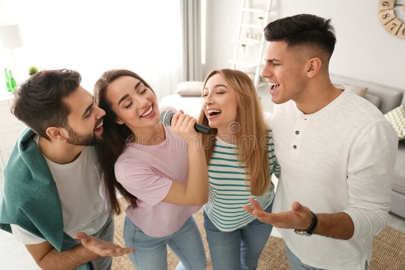 Happy friends singing karaoke together. Happy friends singing karaoke together