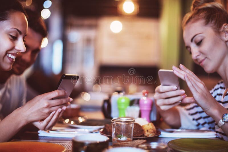 Happy friends take a food picture for instagram