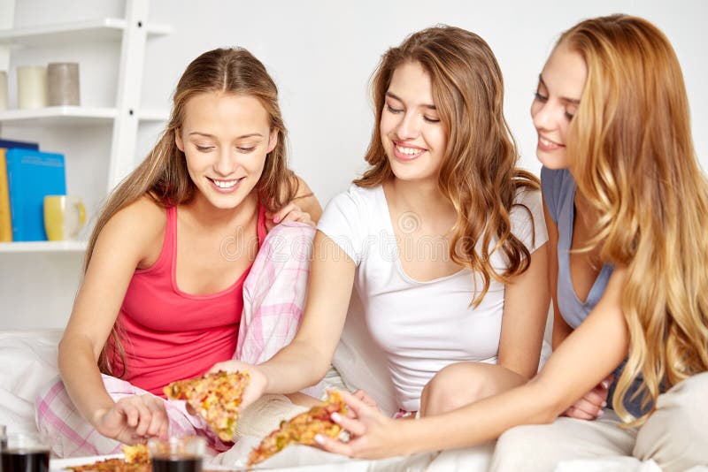 Happy Friends Or Teen Girls Eating Pizza At Home Stock