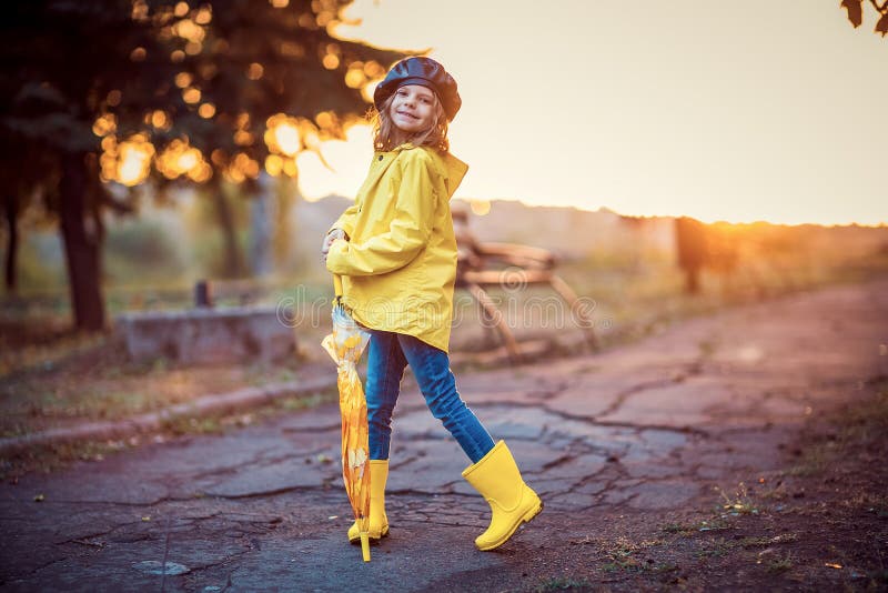 Happy funny child girl with umbrella in rubber boots stock photos Happy funny child girl with umbrella in rubber boots stock photos