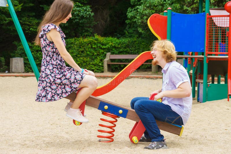 Happy couple on playground royalty free stock photo