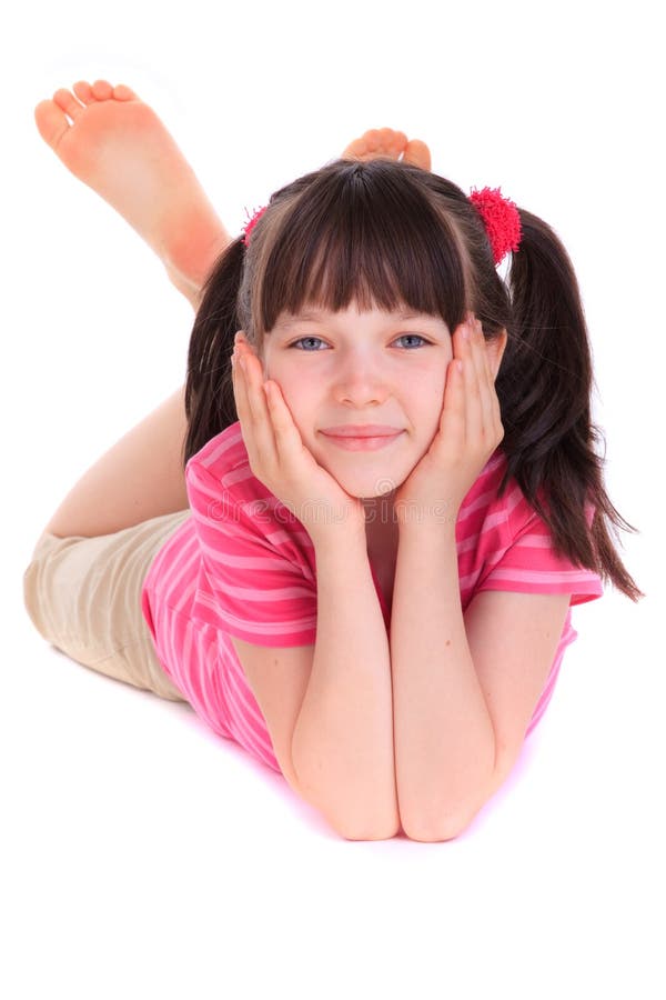 Happy young girl wearing pink top lying on ground, isolated on white background. Top smiling cheerful stock images, royalty-free photos and pictures